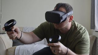 Person playing Oculus Quest with two controllers