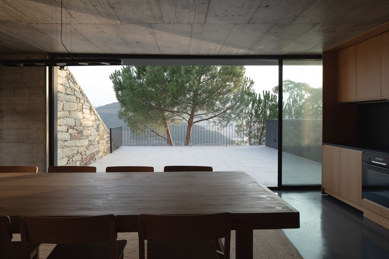 The middle level includes the kitchen and dining area, opening out onto the pool terrace
