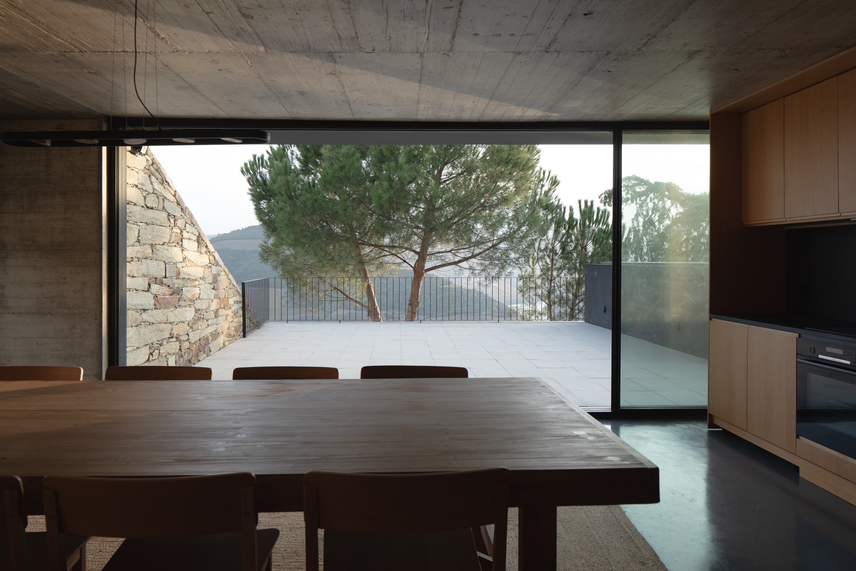 The middle level includes the kitchen and dining area, opening out onto the pool terrace