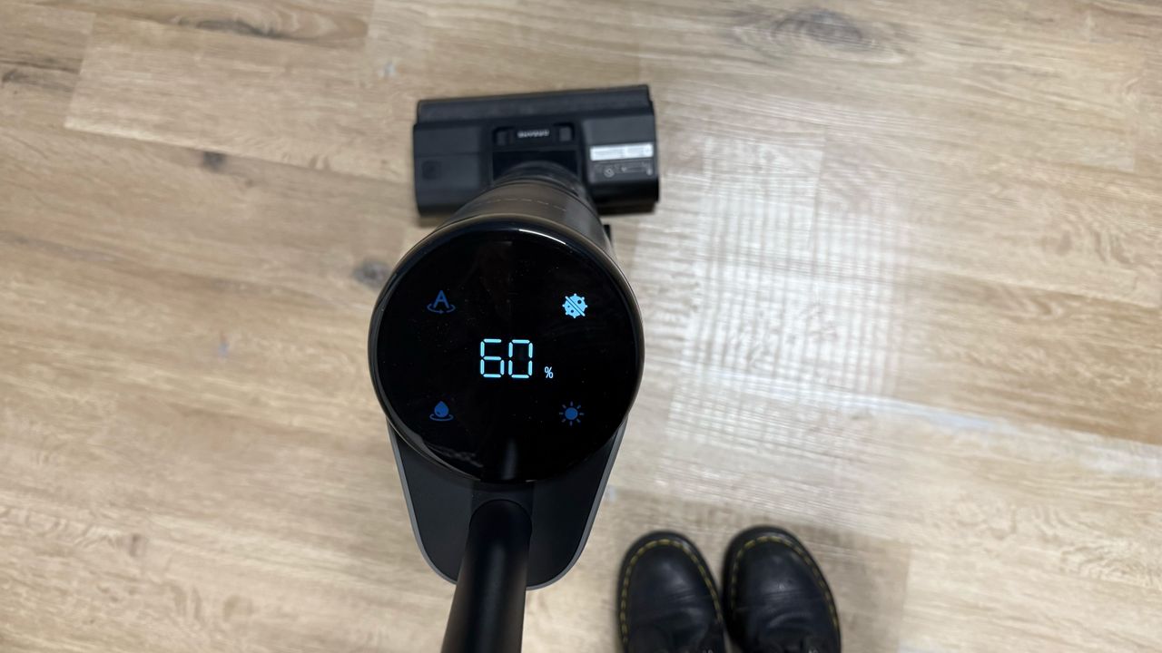 a photograph of the dreame h12 pro wet and dry vacuum cleaner cleaning up eggs and syrup