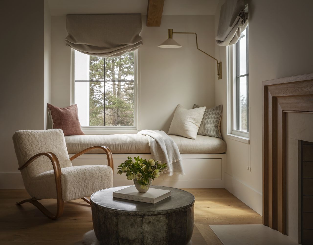 A cozy window seat with a comfortable chair and coffee table closeby