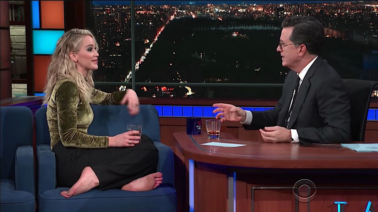 Stephen Colbert and Jennifer Lawrence share a drink