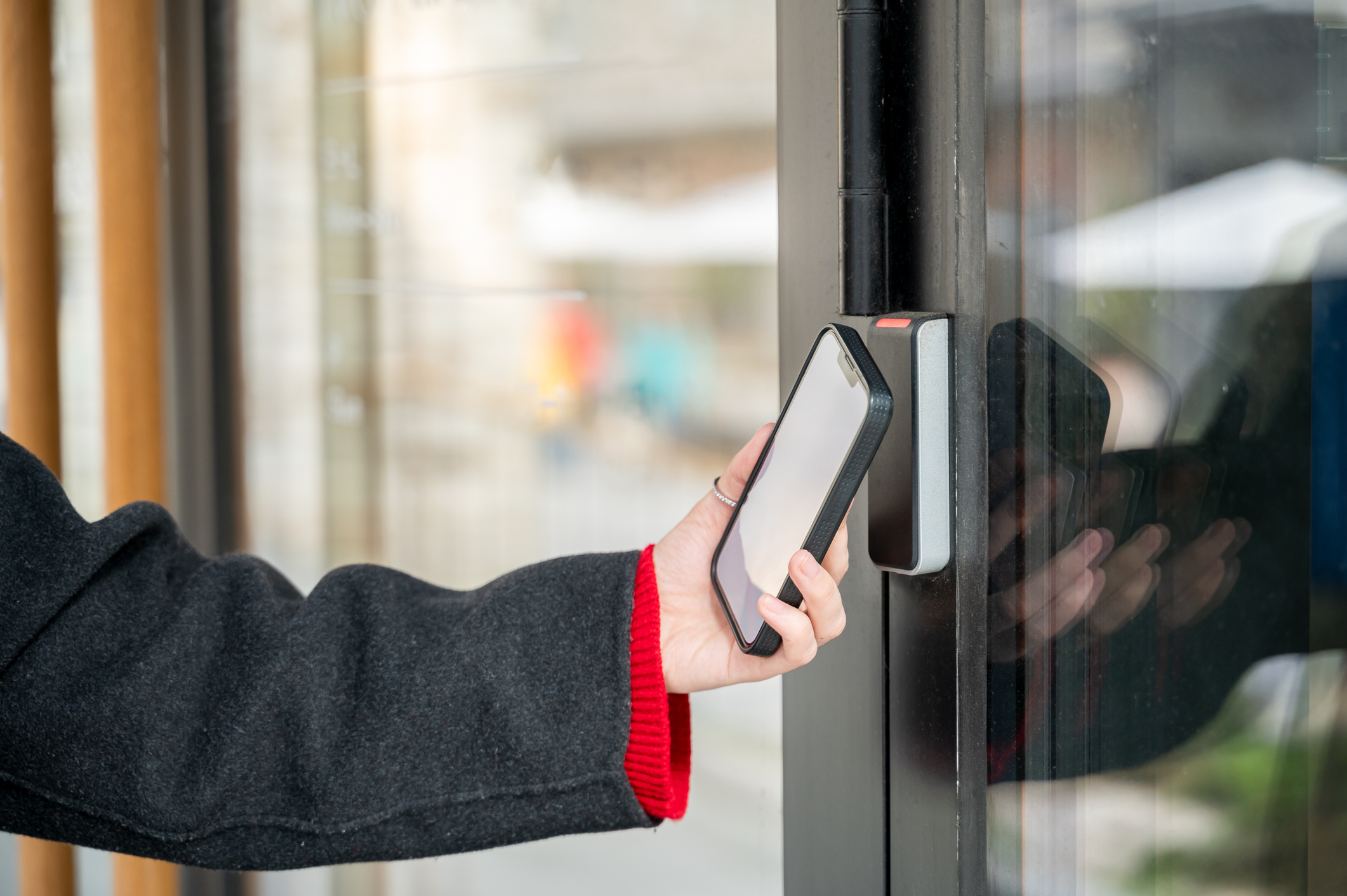 a person using their smartphone to activate the smart lock to unlock the front door