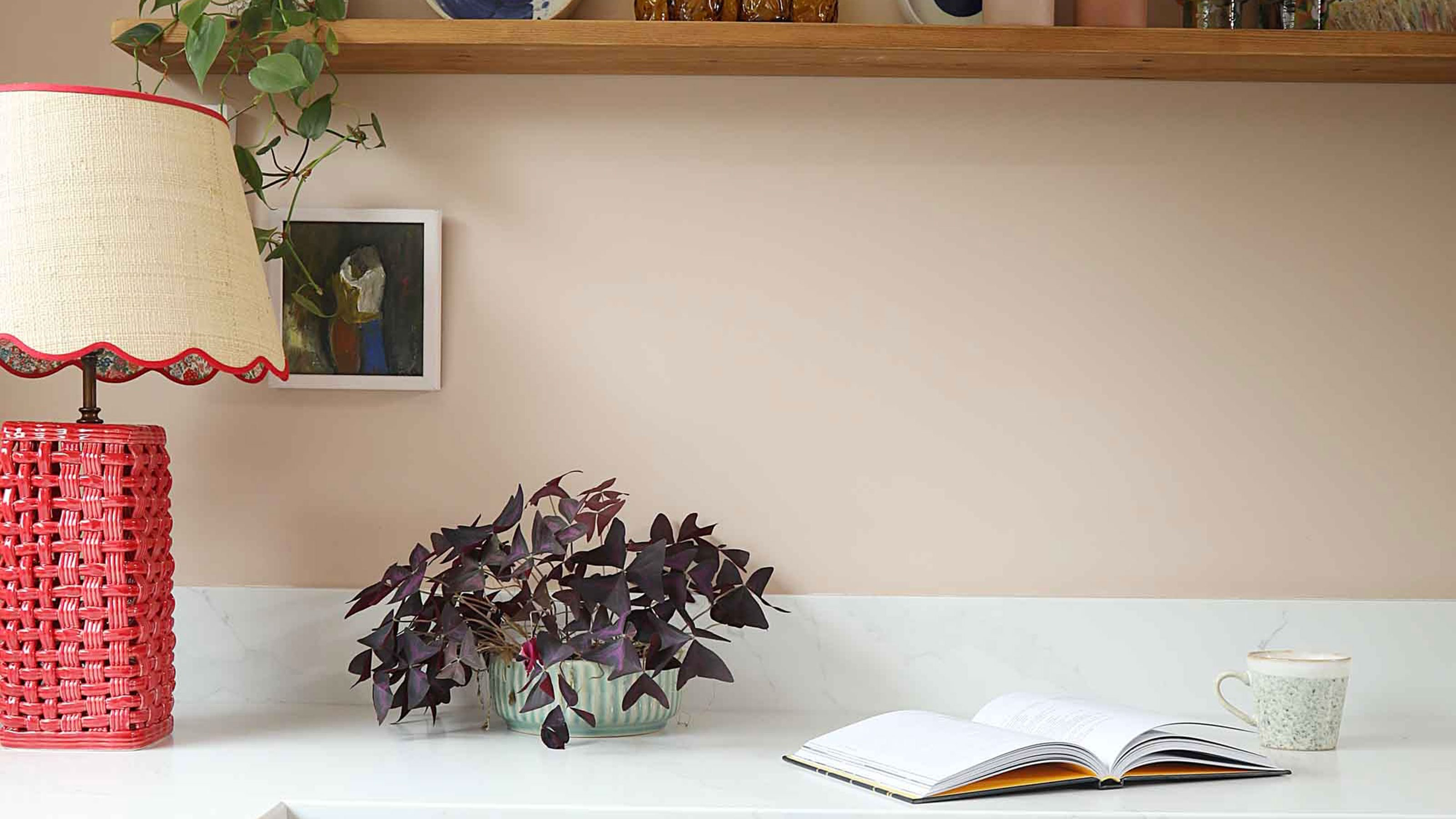Lamp with red woven base on marble kitchen counter