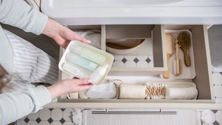 woman looking at organised drawers, which have drawer dividers