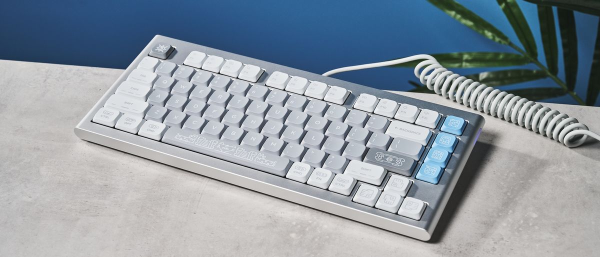 The NuPhy Nos75 mechanical keyboard on a stone surface with a blue background