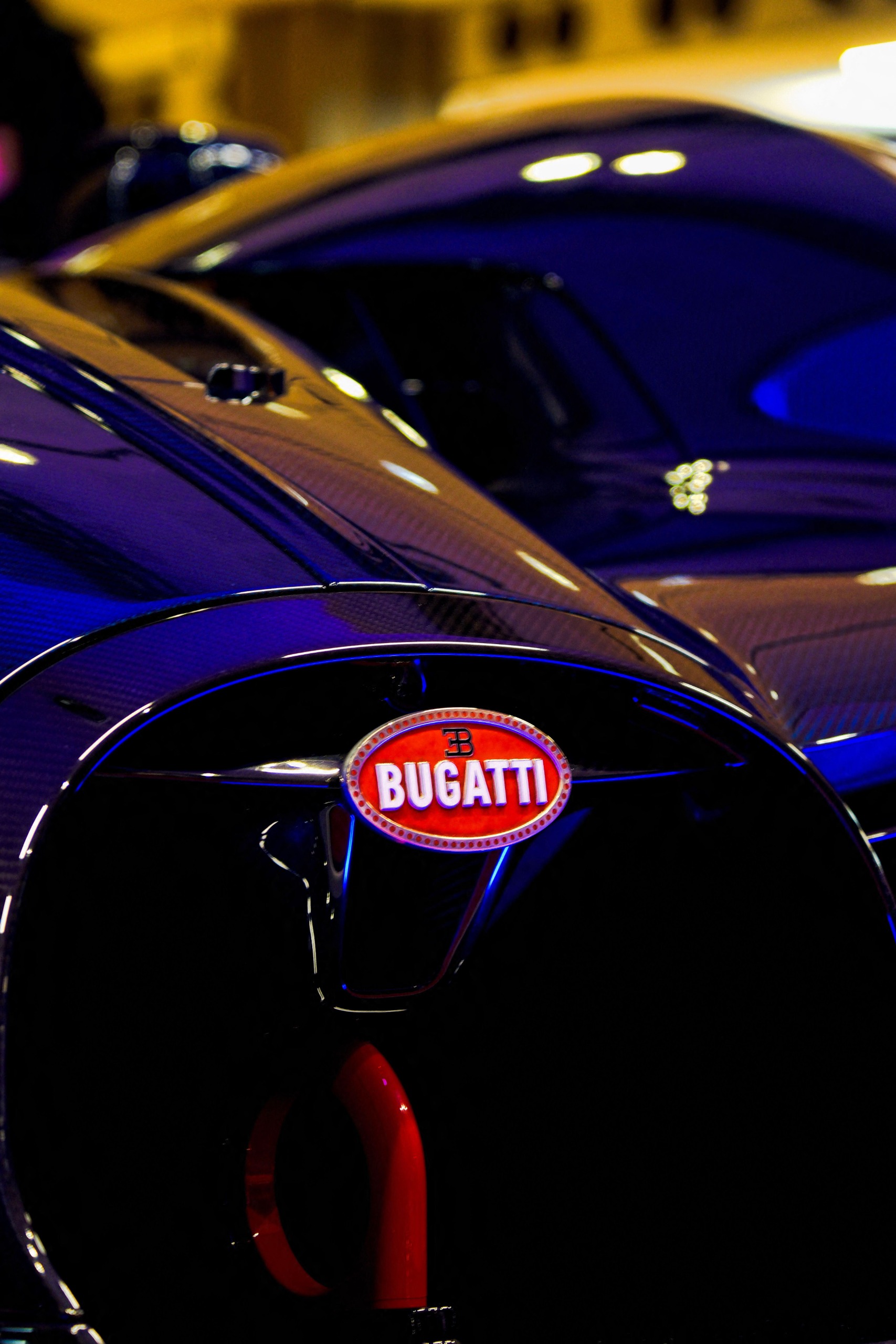 The front end of a Bugatti Bolide, zoomed in so all you can see is the grille and badge