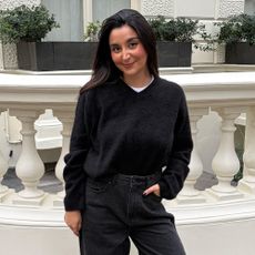 Woman wears white t-shirt and barrel-leg jeans