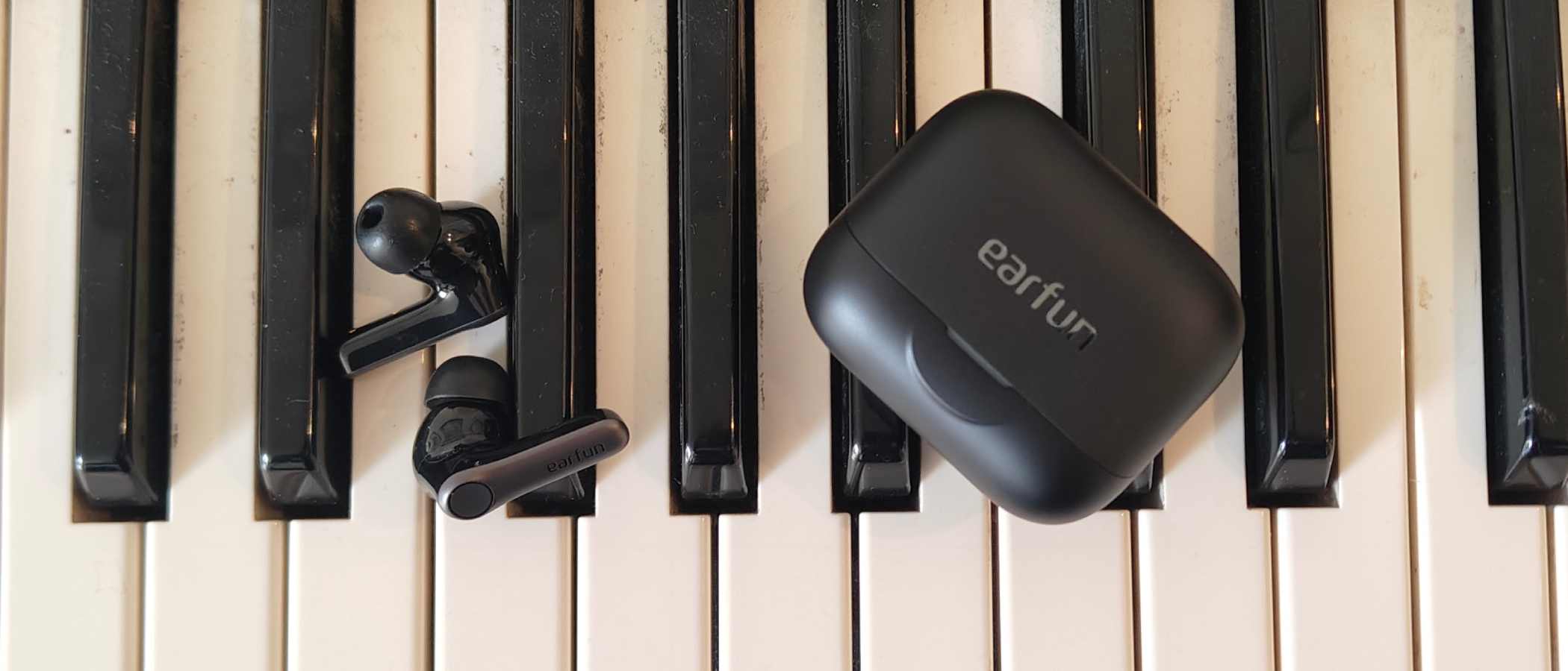 The Earfun Air Pro 4 Plus on top of a keyboard.