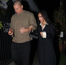 Zoe Kravitz with Channing Tatum in a white button down, black coat, and purple shoes