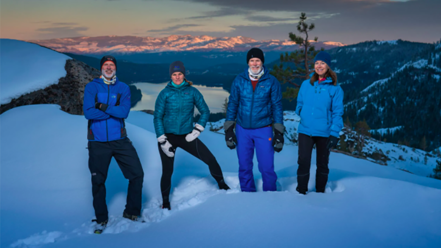 Four hikers on a snowy mountain