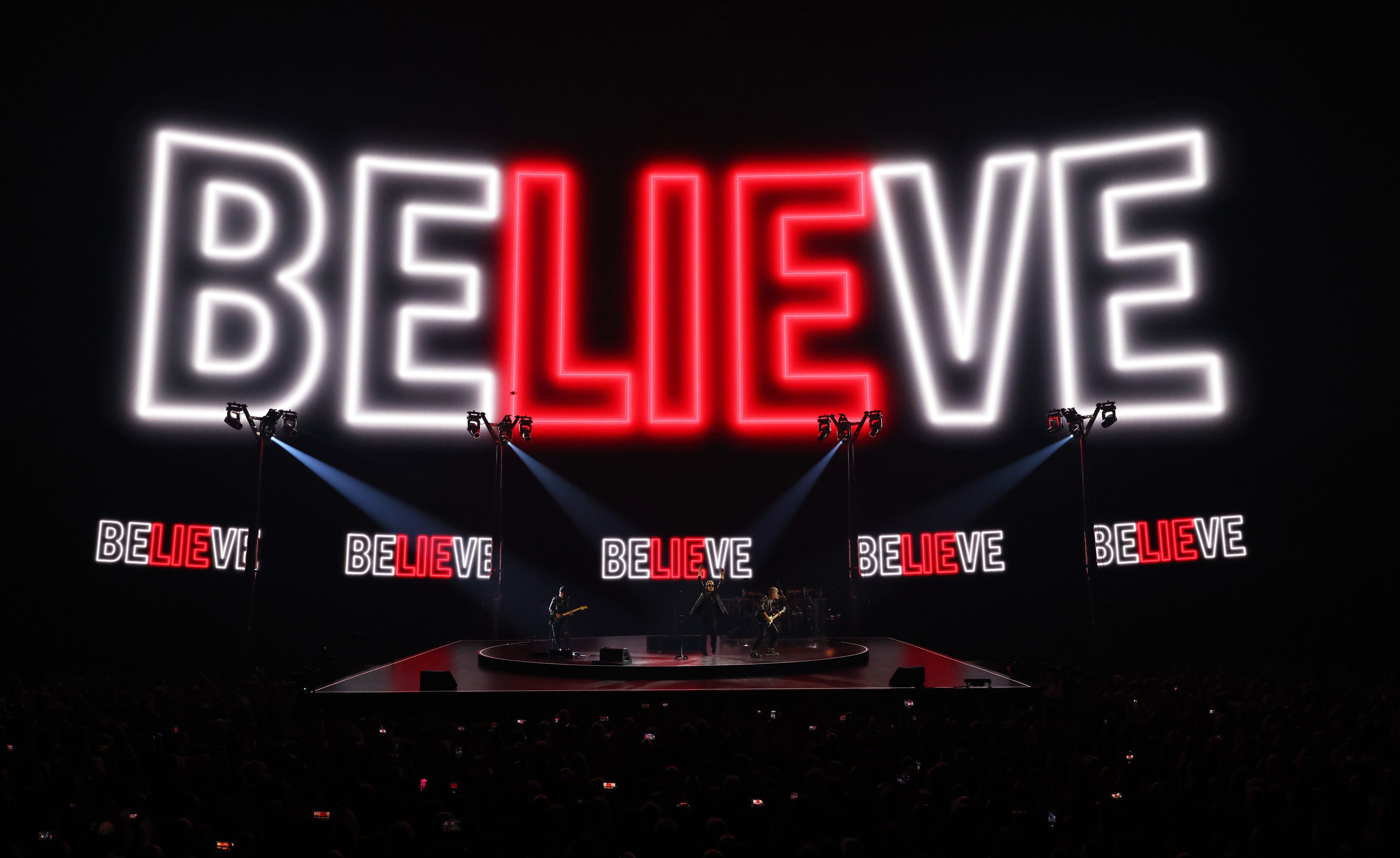 The word BELIEVE illuminated behind U2 at the opening of the Vegas Sphere.