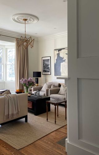 White living room painted in Benjamin Moore Swiss Coffee by Kelly Hopter