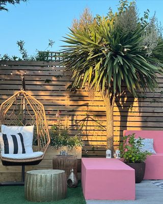 An outdoor patio space with pink furniture