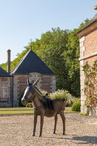 Planted donkey sculpture from Les Lalanne Sotheby's sale, seen in garden