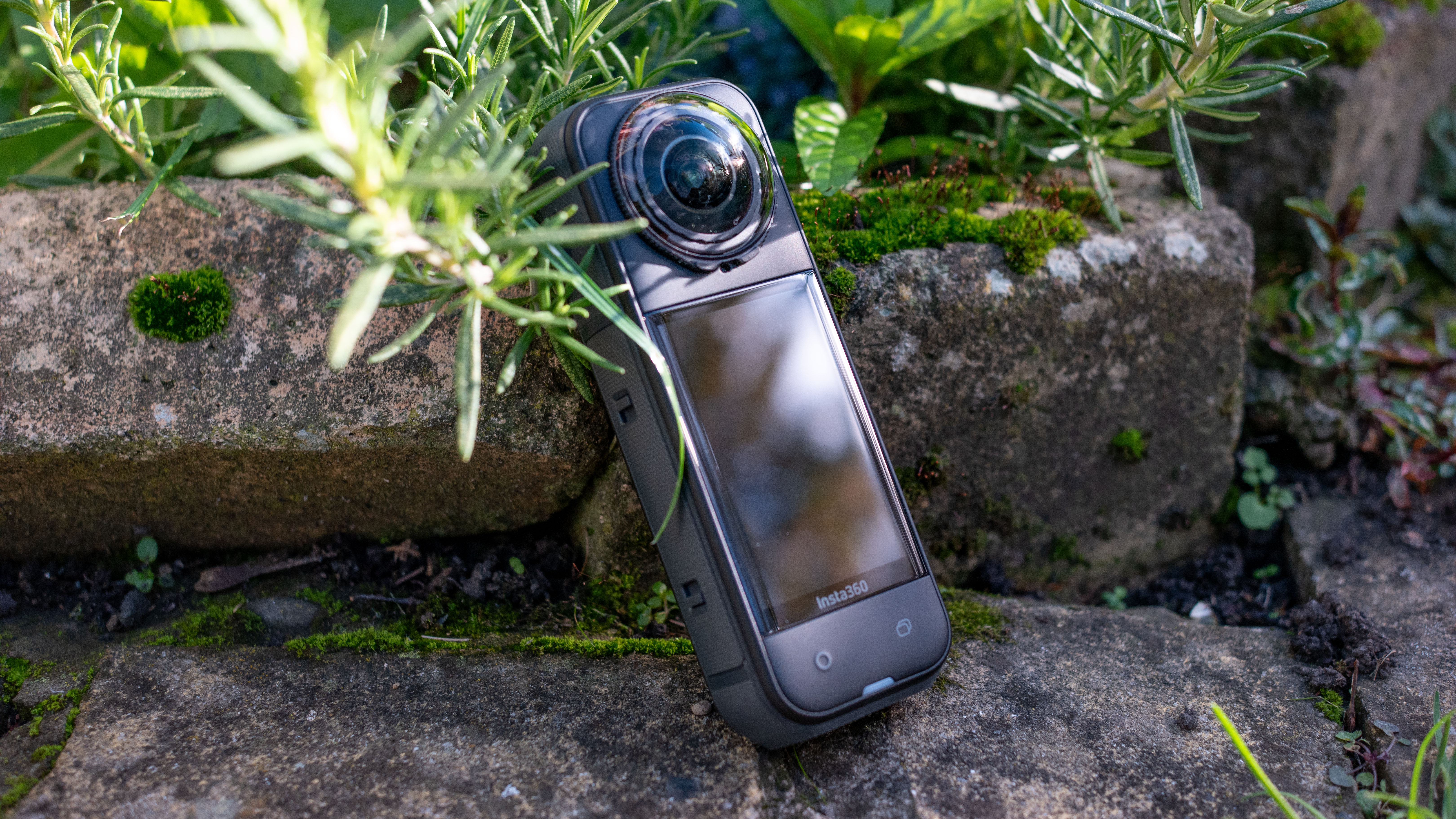 The Insta360 X5 and X4 Air action cameras in an outdoor setting under natural light