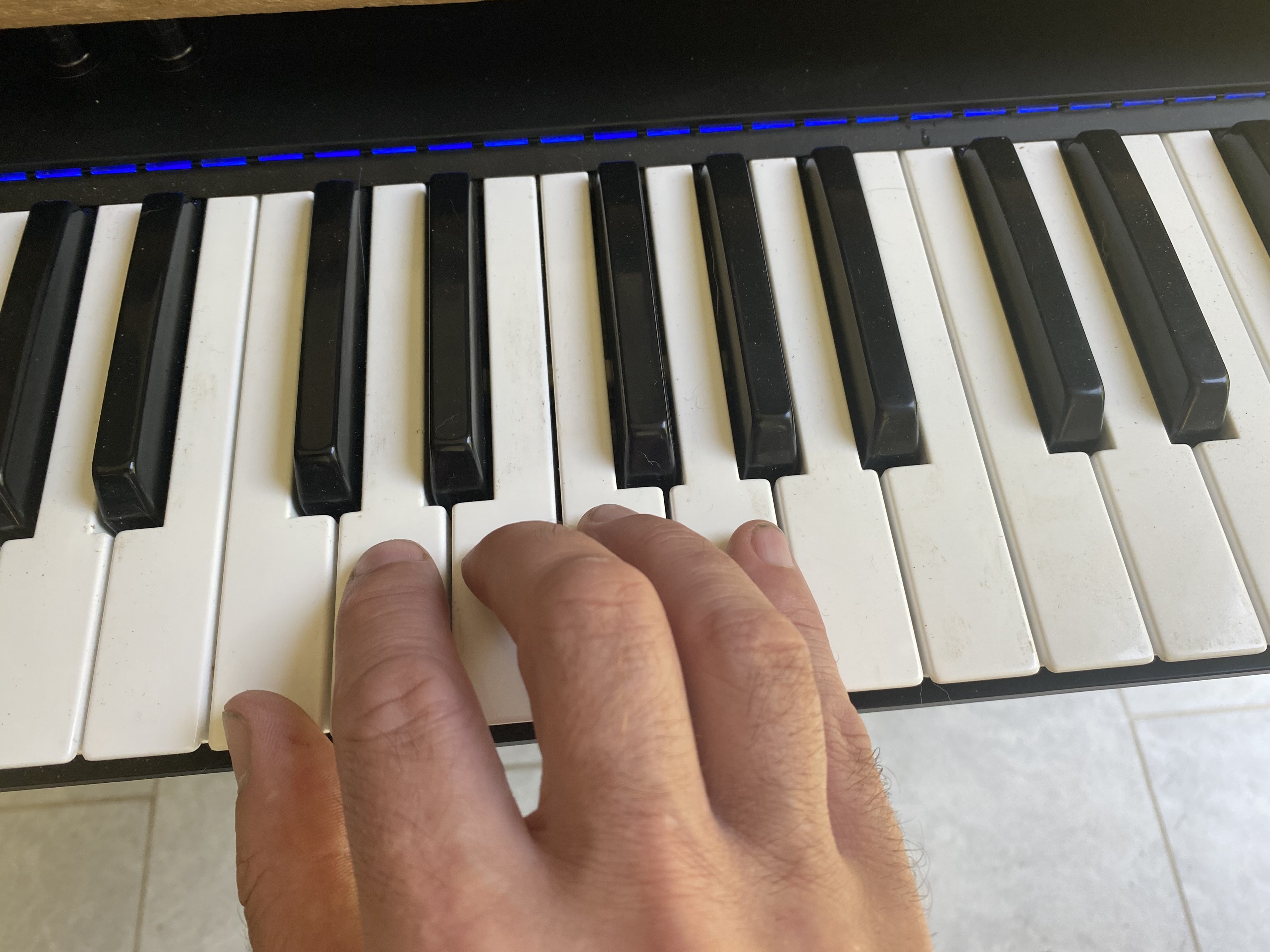 Right hand on a piano keyboard