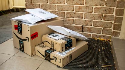 Amazon prime boxes and envelopes delivered to a front door of residential building
