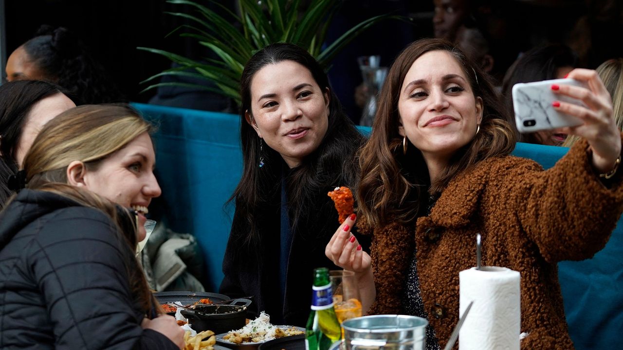 A group of women dine outdoors 