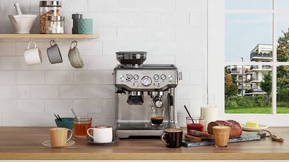 Breville Barista Express on a countertop with coffee mugs all around it