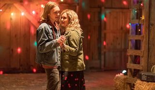 Charlie Plummer and Katherine Langford dancing in a barn in Spontaneous.