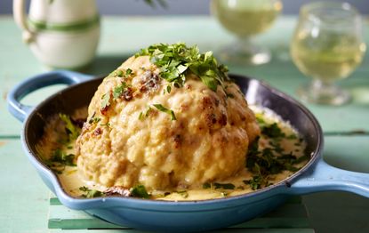 Whole roasted cauliflower with thyme and cheese sauce