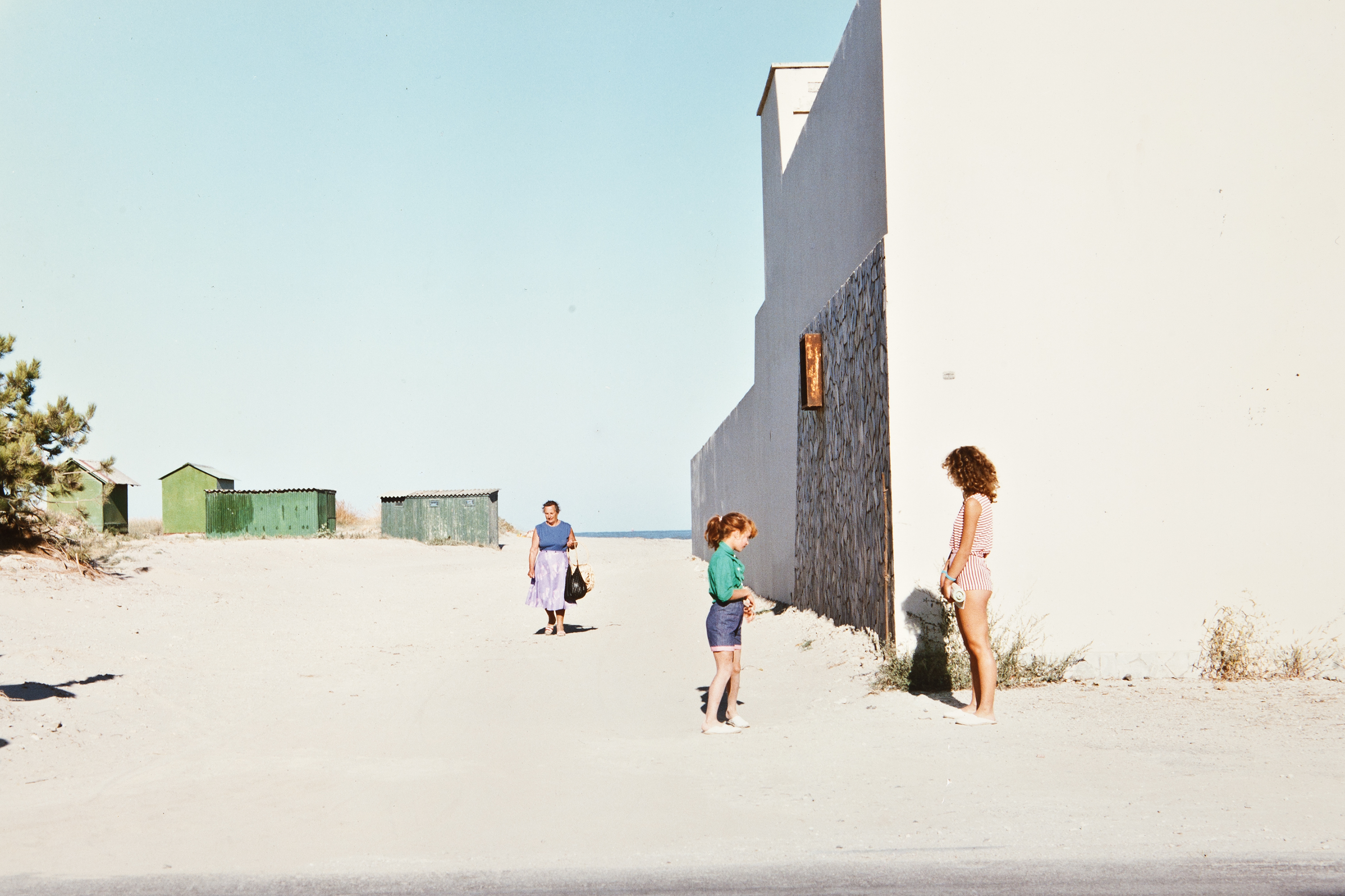 photograph of people near beach, from the exhibition &lsquo;Luigi Ghirri: Felicit&agrave;&rsquo; at Thomas Dane Gallery, London