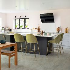 kitchen diner with grey island and green bar stools