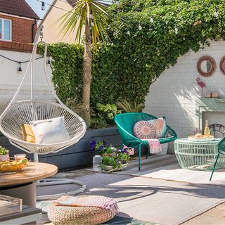 garden area with hanging chair and turquoise chair