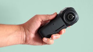 The Insta360 ONE RS 1-Inch 360 Edition camera on a green background