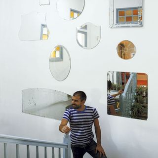 hallway with stairwell and mirrors