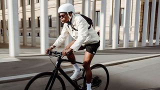 A cyclist riding a Specialized sirrus in a city 