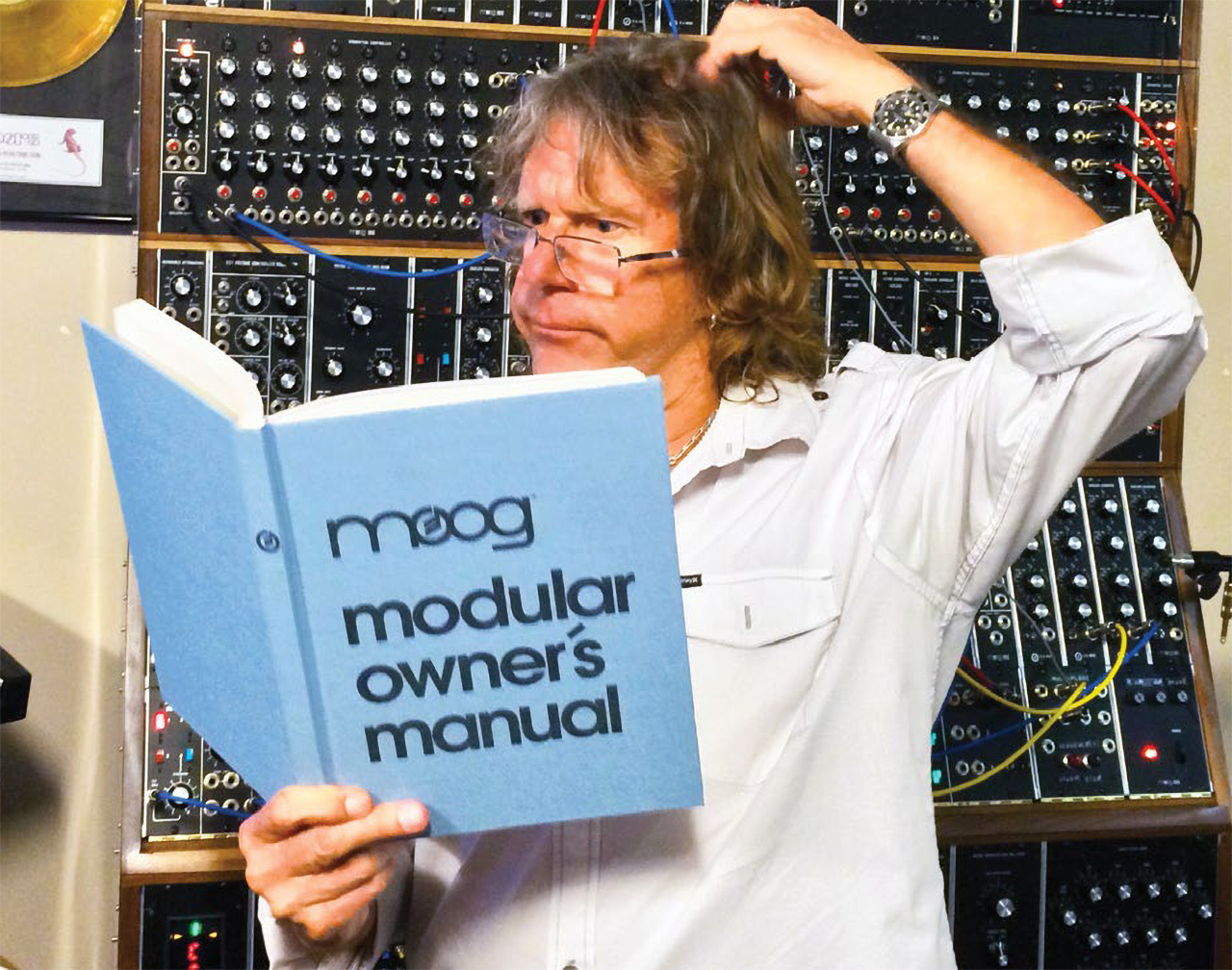 Keith Emerson with a Moog instruction manual