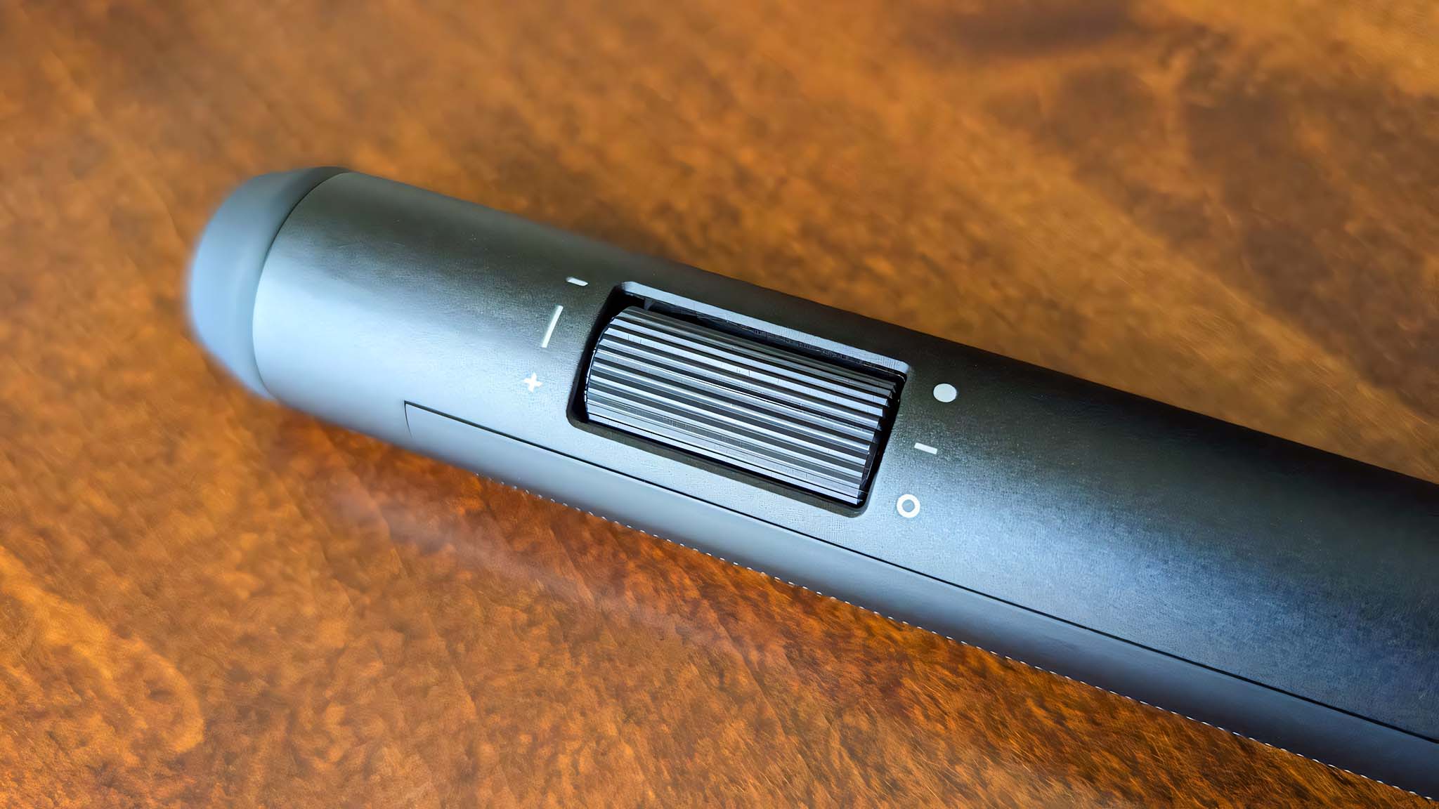 Close-up of the ASUS ROG Aura Monitor Light Bar brightness dial.