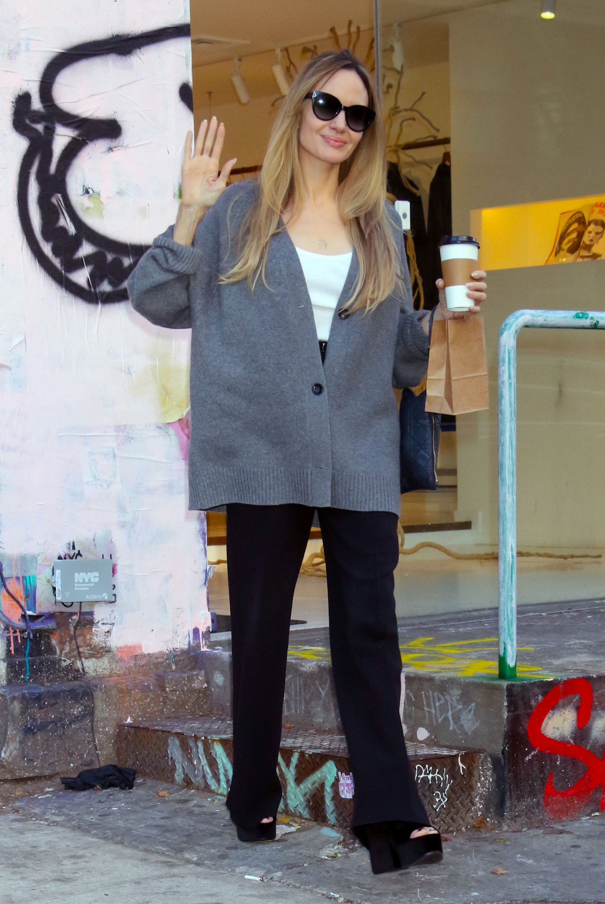 An image of Angelina Jolie wearing peep-toe shoes, an example of a summer 2025 fashion trend for over 50s, while leaving Atelier Jolie in New York.