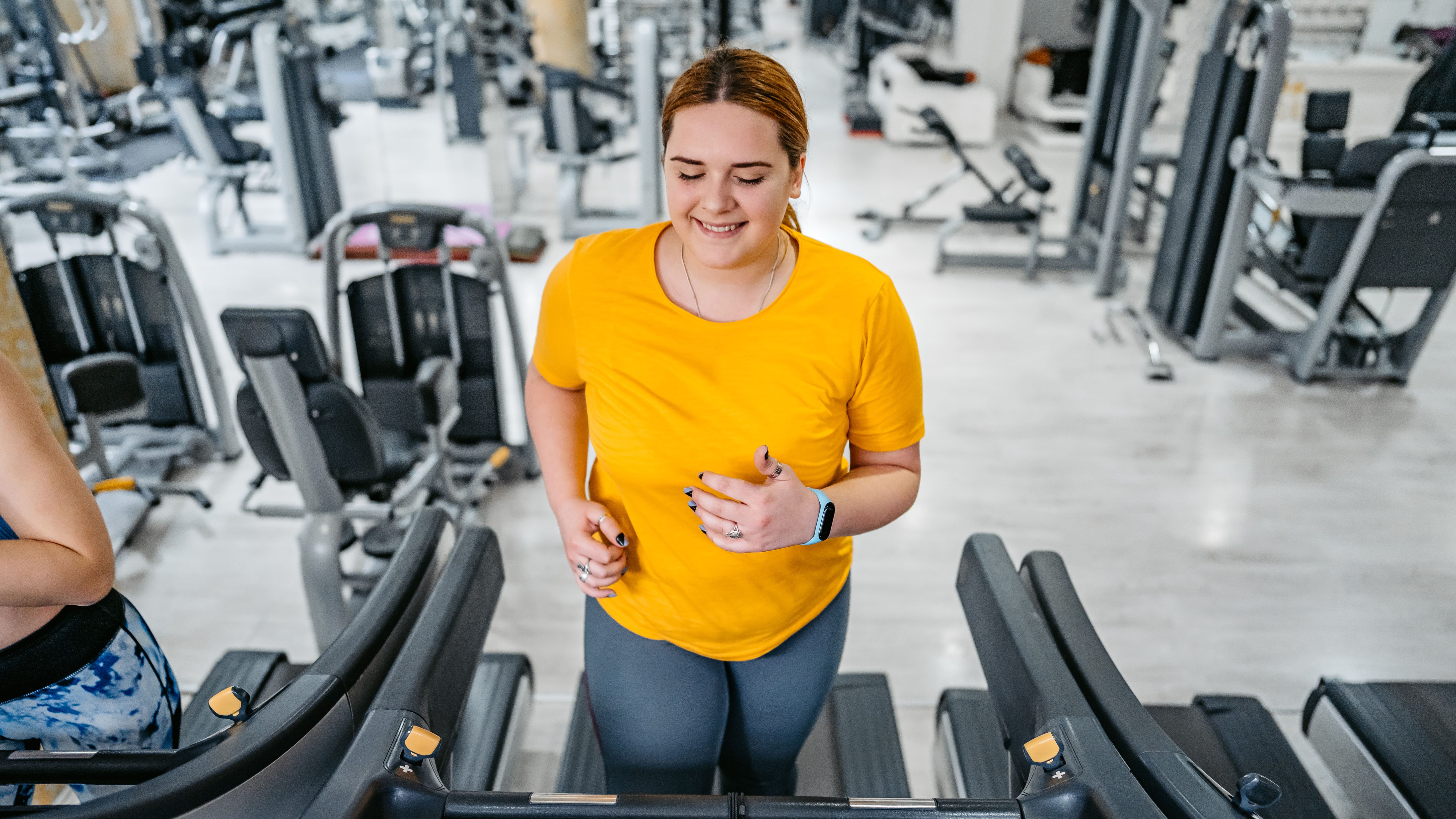 Woman running on treadmill at gym