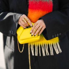 Dip powder nails - gradient manicure holding yellow handbag