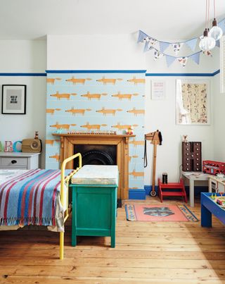 how to design a kid's room: child's bedroom with graphic printed wallpaper, original wooden flooring and other colourful, decorative additions