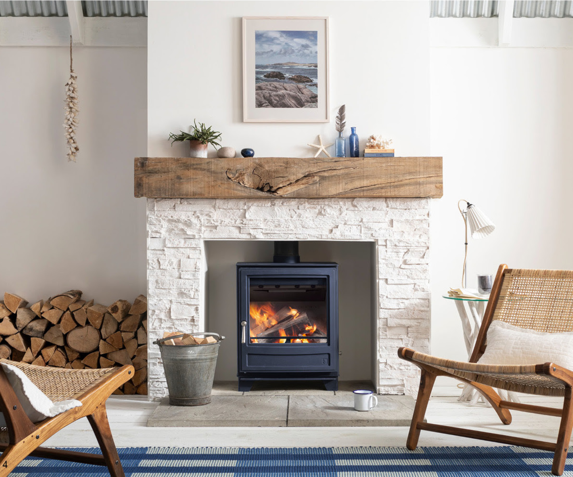 blue log burner in cream fireplace with wooden hearth