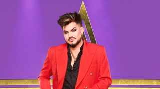 Adam Lambert from Starstruck wearing a red jacket against a purple background. 