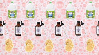Pink bubbly background with cut outs of lemons, white vinegar and essential oil