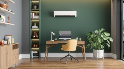 Home Office Interior With Air Conditioner, Table, Desktop Computer And Wooden Cabinet