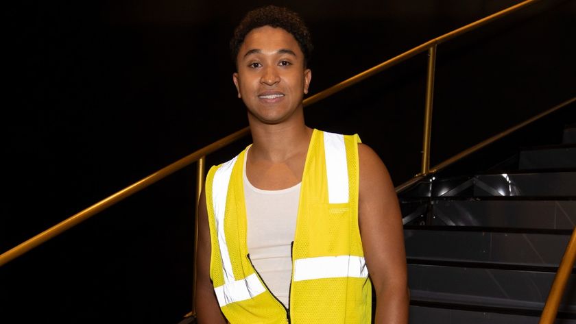 Brandon Armstrong smiling for the camera while wearing a bright yellow vest on Dancing with the Stars. 
