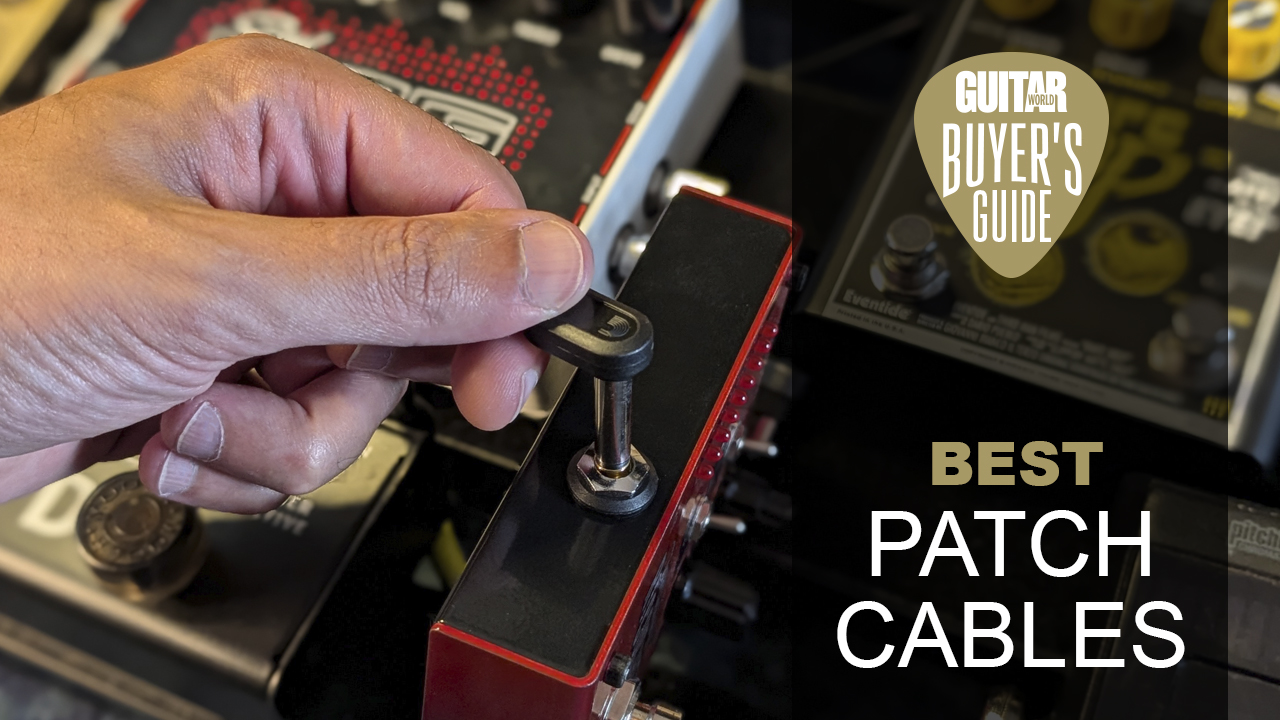 A man places a patch cable into a guitar pedal