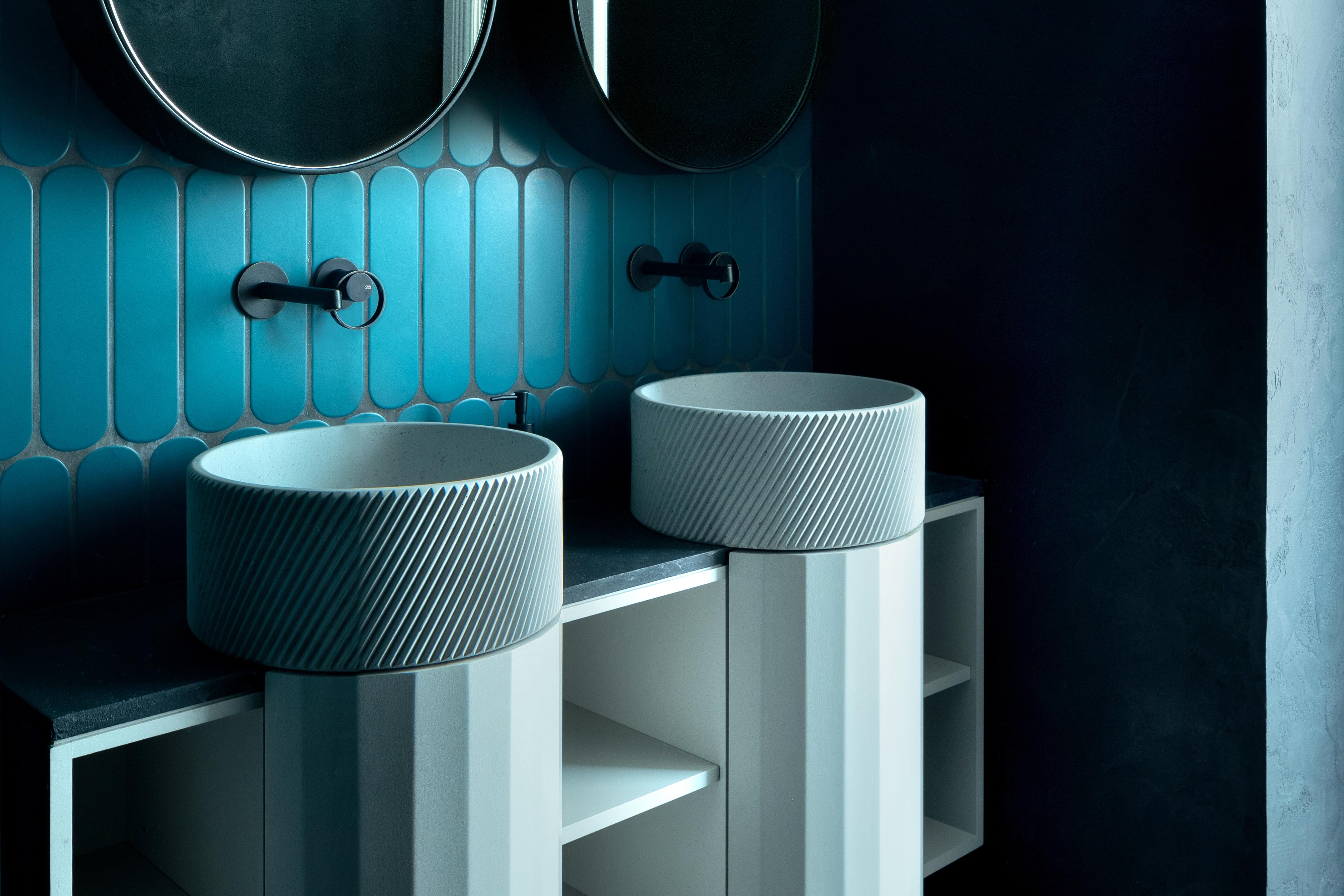 two blue circular washbasins with grooved surface