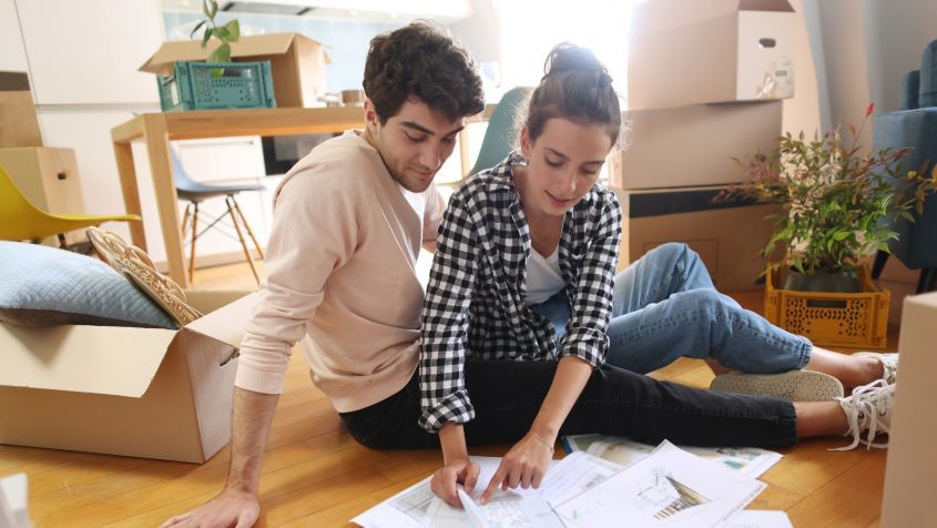 A young couple looking at plans of their new home