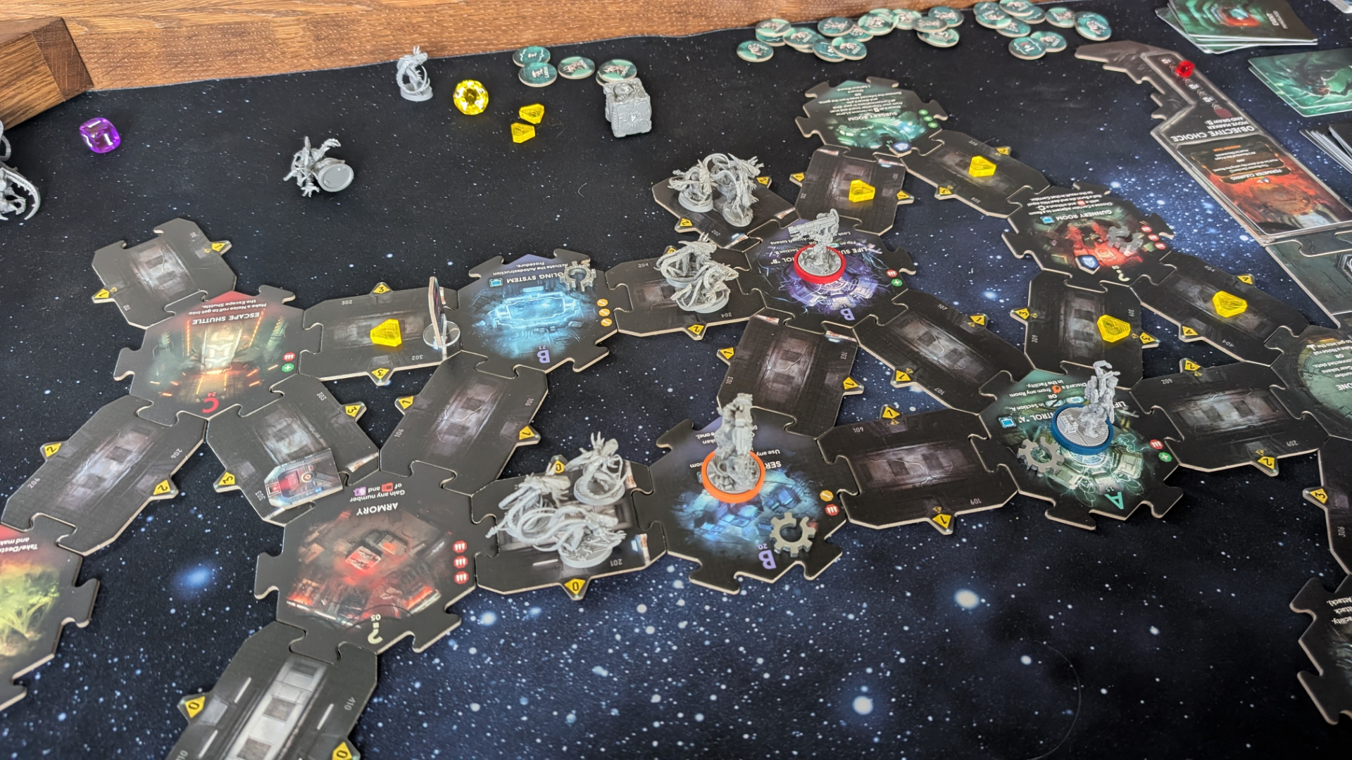 Nemesis: Retaliation pieces, board tiles, and tokens on a gaming table with a starry effect