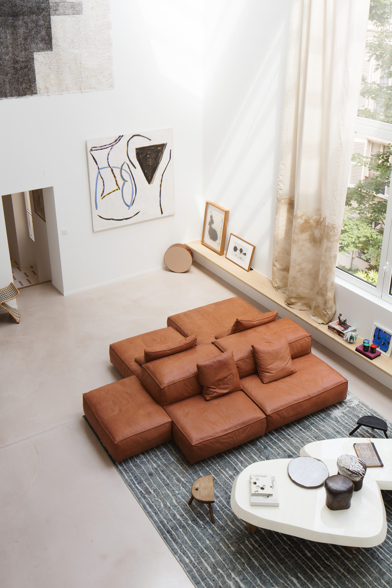 A sofa island comprised of brown leather modular seating components.