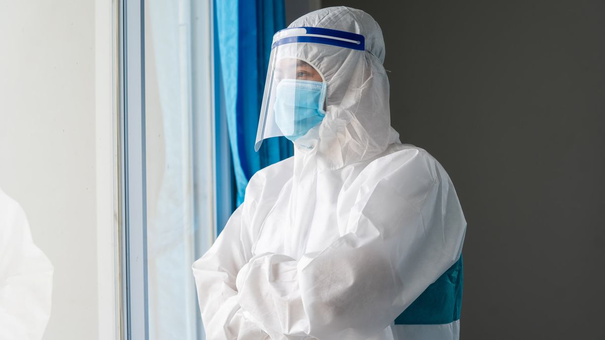 A doctor wearing a face mask and face shield to protect against COVID-19 in a hospital.