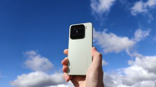 The Xiaomi 15 against a blue sky